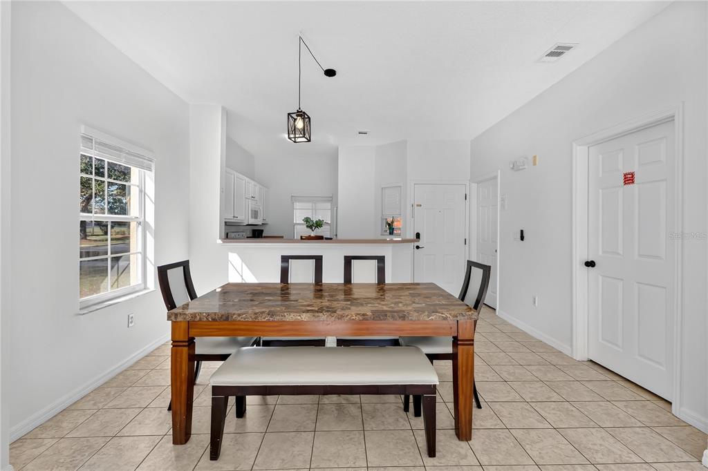 1070 Park Ridge Circle Kissimmee, FL 34746 - Photo 10 of 36 a view of a dining room with furniture and wooden floor