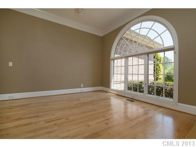 1709 Verdict Ridge Drive Denver, NC 28037 - Photo 3 of 16 an empty room with wooden floor and windows