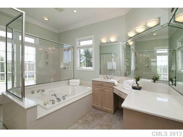 1709 Verdict Ridge Drive Denver, NC 28037 - Photo 5 of 16 a bathroom with a tub a double vanity sink a toilet a mirror and shower