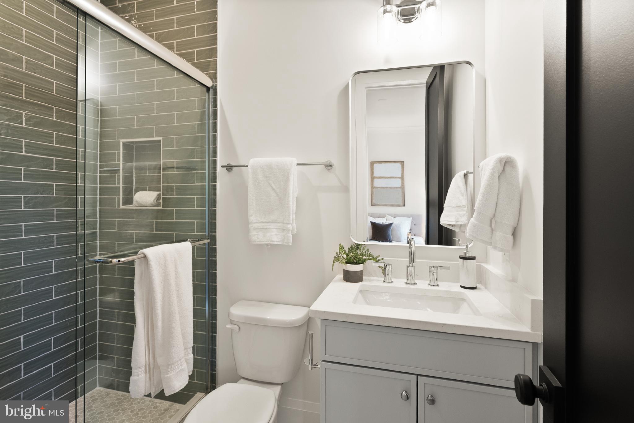 7806 Carteret Road Bethesda, MD 20817 - Photo 18 of 58 a bathroom with a sink mirror toilet and shower