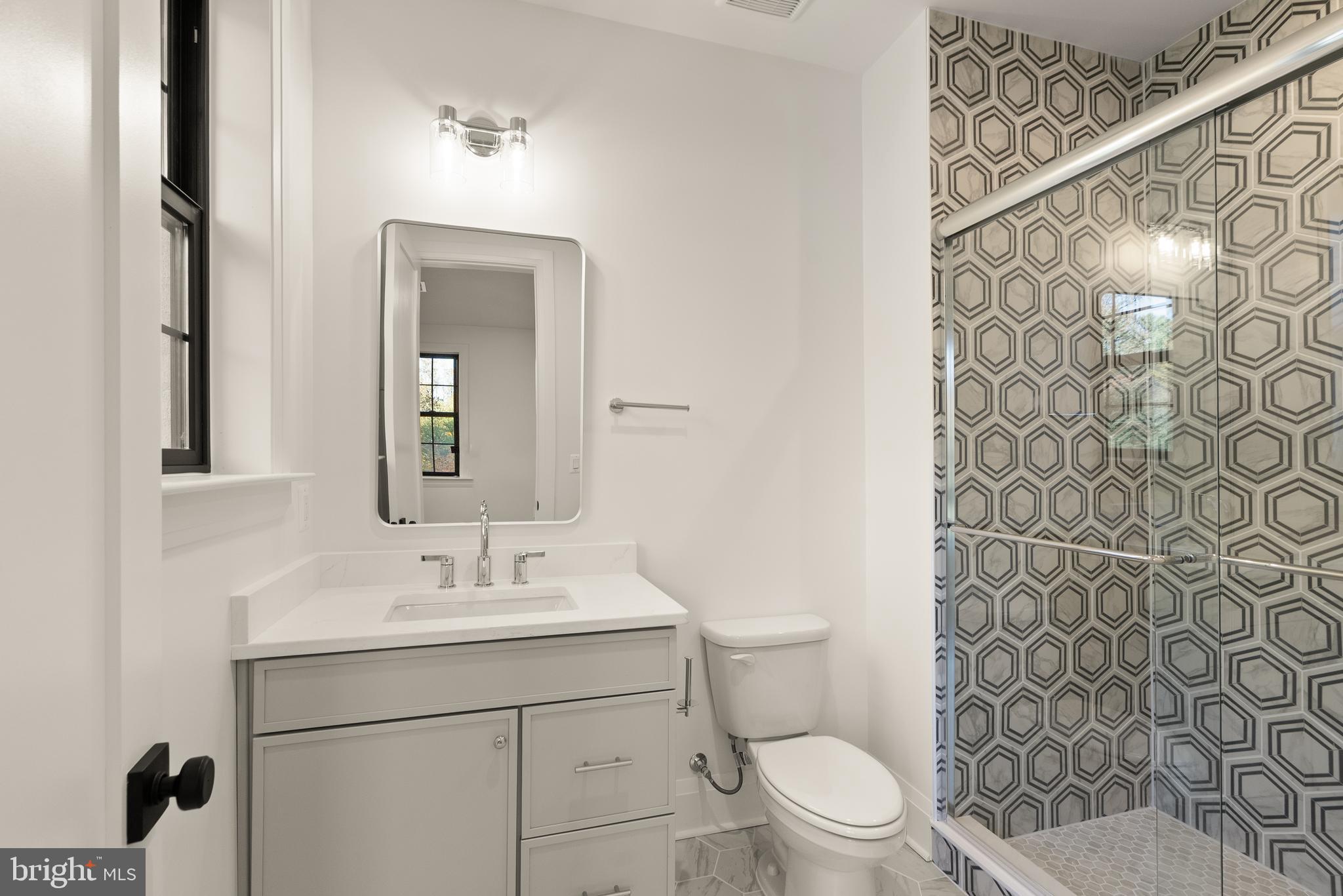 7806 Carteret Road Bethesda, MD 20817 - Photo 36 of 58 a bathroom with a sink a toilet and shower curtain