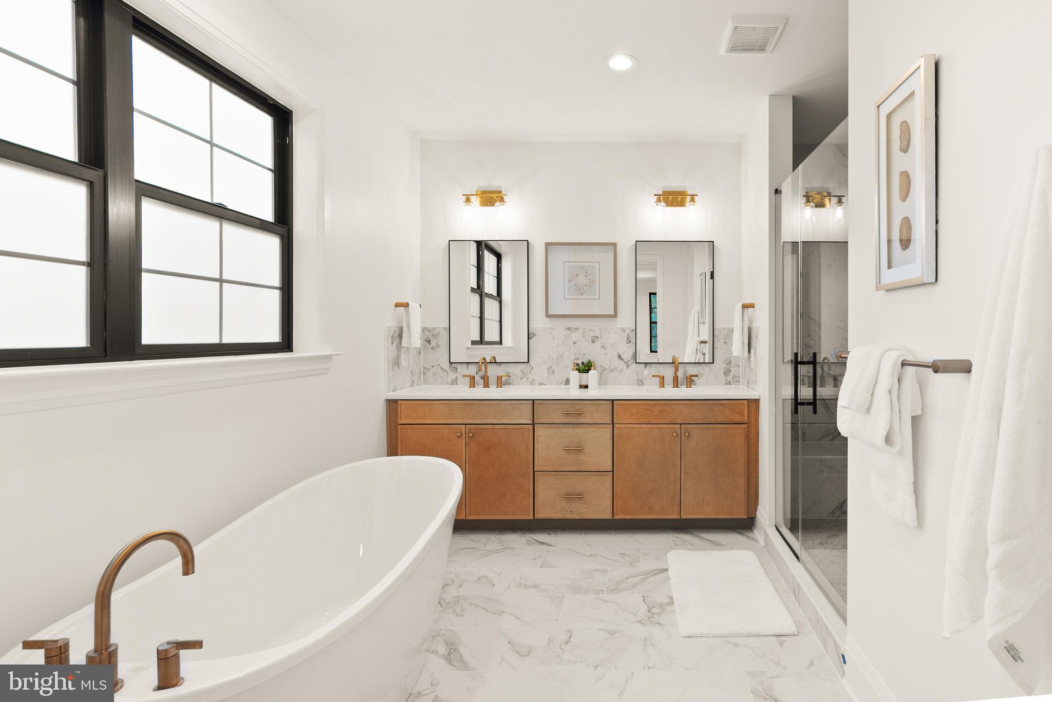7806 Carteret Road Bethesda, MD 20817 - Photo 40 of 58 a bathroom with a granite countertop sink mirror and a bathtub