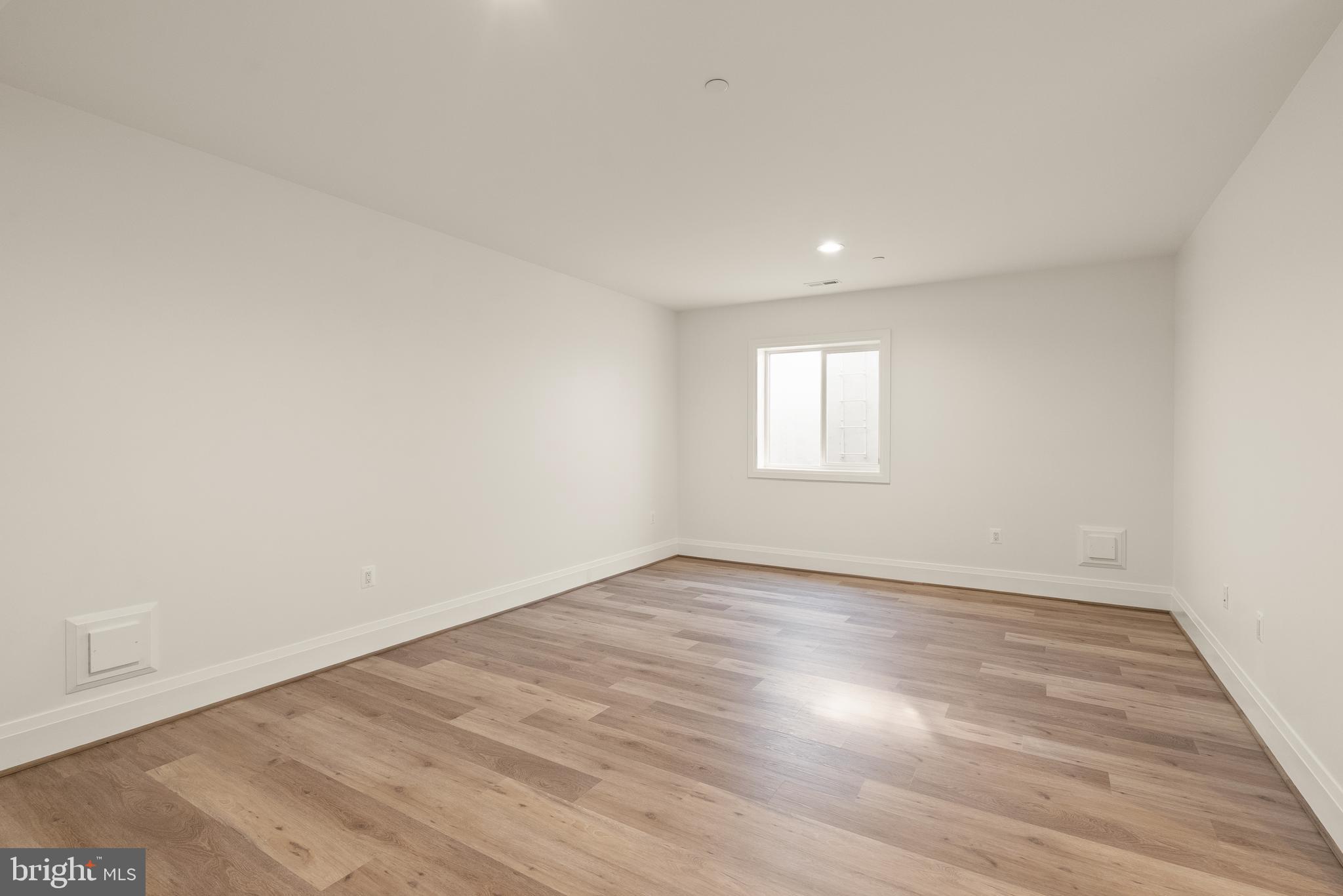 7806 Carteret Road Bethesda, MD 20817 - Photo 51 of 58 an empty room with wooden floor and window