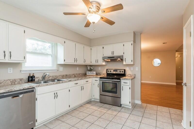401 Ashley Drive Crestview, FL 32536 - Photo 11 of 36 a kitchen with a stove sink and cabinets