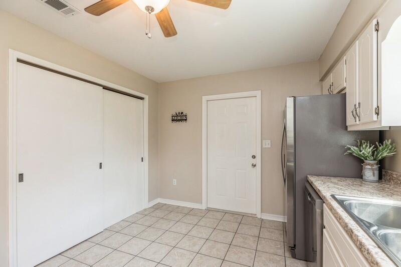 401 Ashley Drive Crestview, FL 32536 - Photo 12 of 36 a kitchen with granite countertop a refrigerator and a sink
