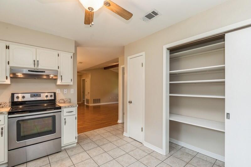401 Ashley Drive Crestview, FL 32536 - Photo 13 of 36 a kitchen with white cabinets and stainless steel appliances