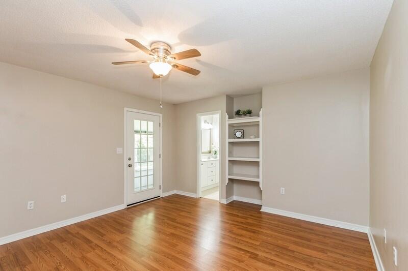 401 Ashley Drive Crestview, FL 32536 - Photo 15 of 36 a view of empty room with wooden floor and fan