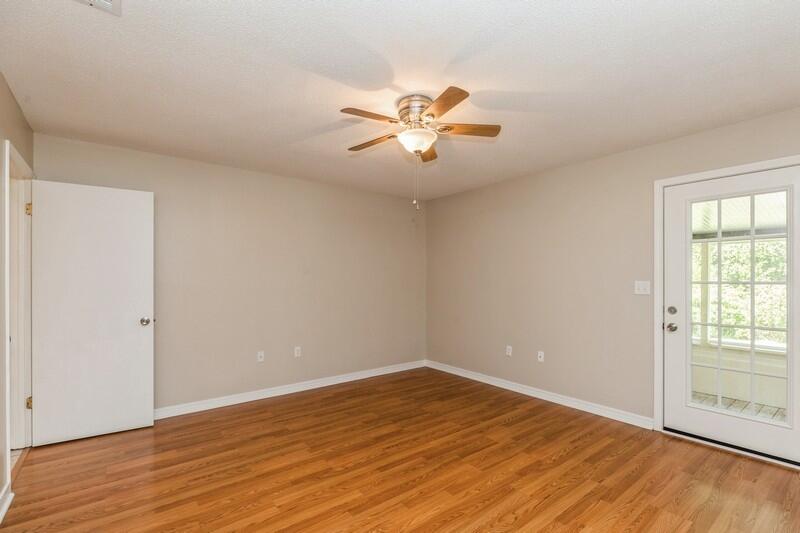 401 Ashley Drive Crestview, FL 32536 - Photo 17 of 36 a view of empty room with wooden floor and fan