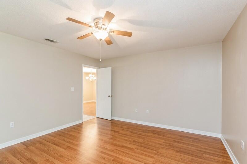 401 Ashley Drive Crestview, FL 32536 - Photo 18 of 36 an empty room with wooden floor and windows