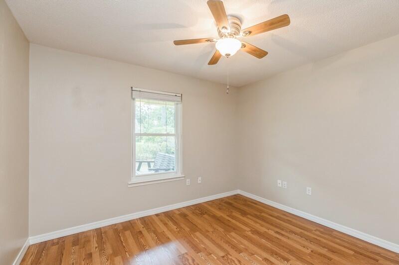 401 Ashley Drive Crestview, FL 32536 - Photo 25 of 36 wooden floor in an empty room with a window