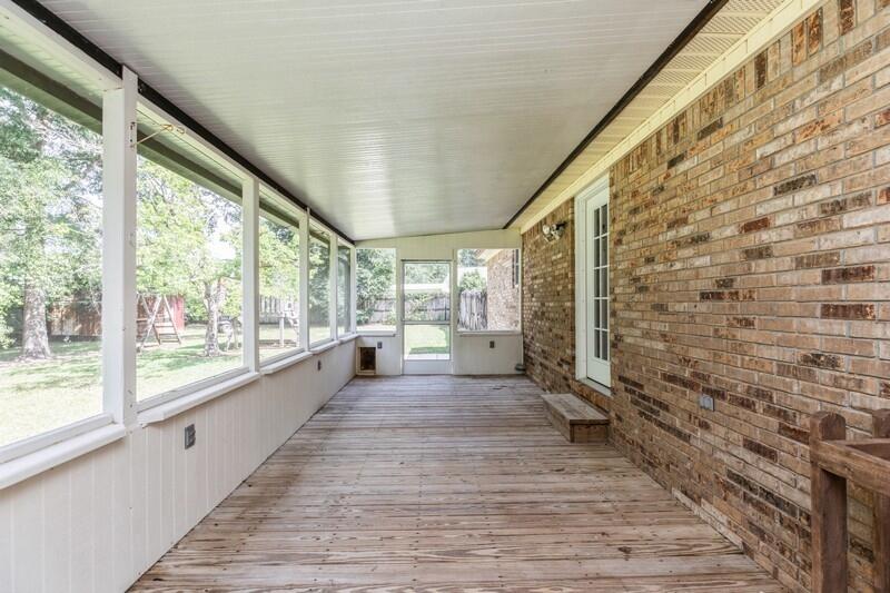 401 Ashley Drive Crestview, FL 32536 - Photo 29 of 36 a view of a porch with wooden floor and brick walls