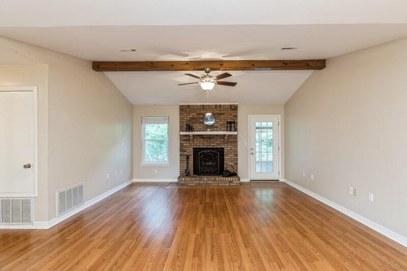 401 Ashley Drive Crestview, FL 32536 - Photo 6 of 36 a view of an empty room with wooden floor fireplace and a window