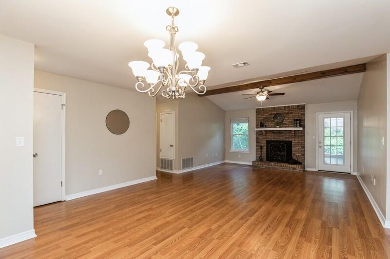 401 Ashley Drive Crestview, FL 32536 - Photo 7 of 36 a view of an empty room with wooden floor and a fireplace