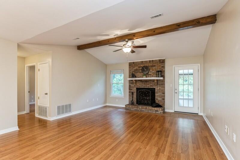 401 Ashley Drive Crestview, FL 32536 - Photo 8 of 36 a view of an empty room with wooden floor fireplace and a window