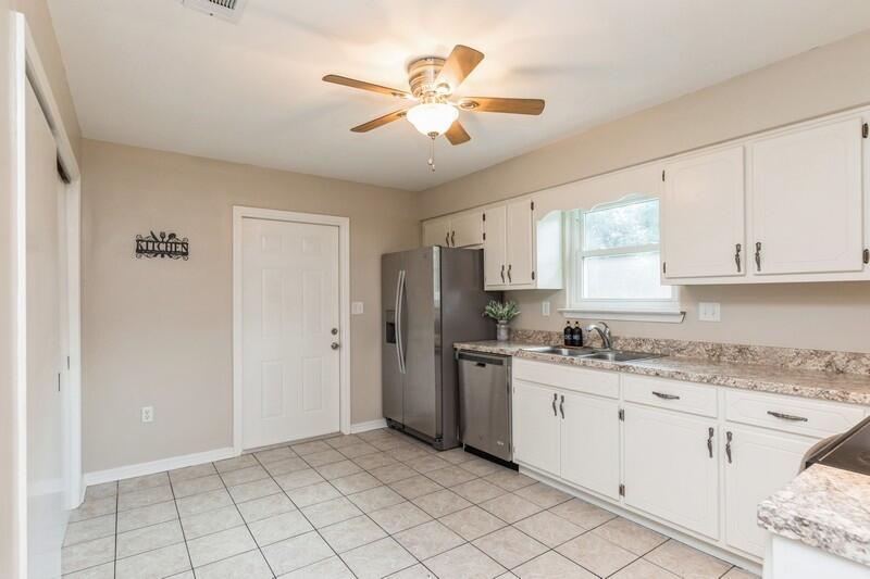 401 Ashley Drive Crestview, FL 32536 - Photo 10 of 36 a kitchen with stainless steel appliances granite countertop a sink a stove a refrigerator and cabinets