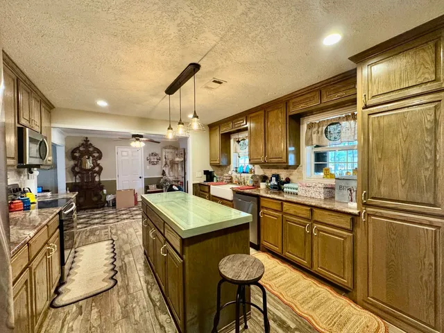 a bedroom with a bed dresser and a window