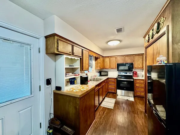 a kitchen with stainless steel appliances a stove a sink and a refrigerator