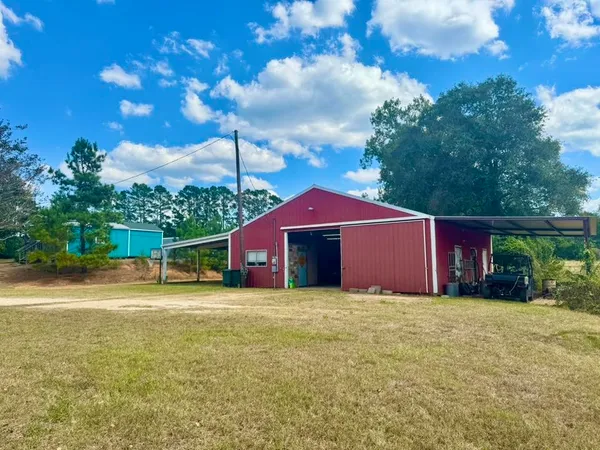 a front view of a house with yard and trees