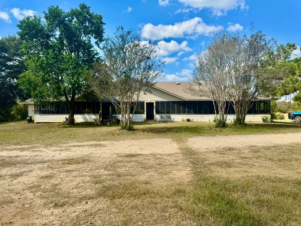 a view of a building with trees in the background