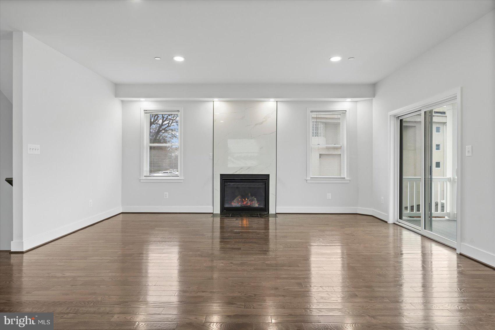 11030 Bird River Grove Road White Marsh, MD 21162 - Photo 29 of 53 an empty room with wooden floor and a fireplace