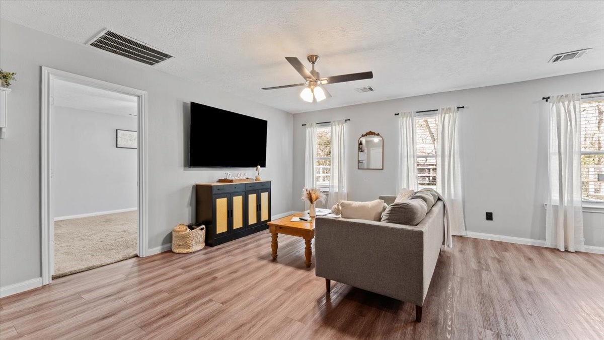 3975 Sam Houston Road Willis, TX 77378 - Photo 13 of 38 a living room with furniture and a flat screen tv