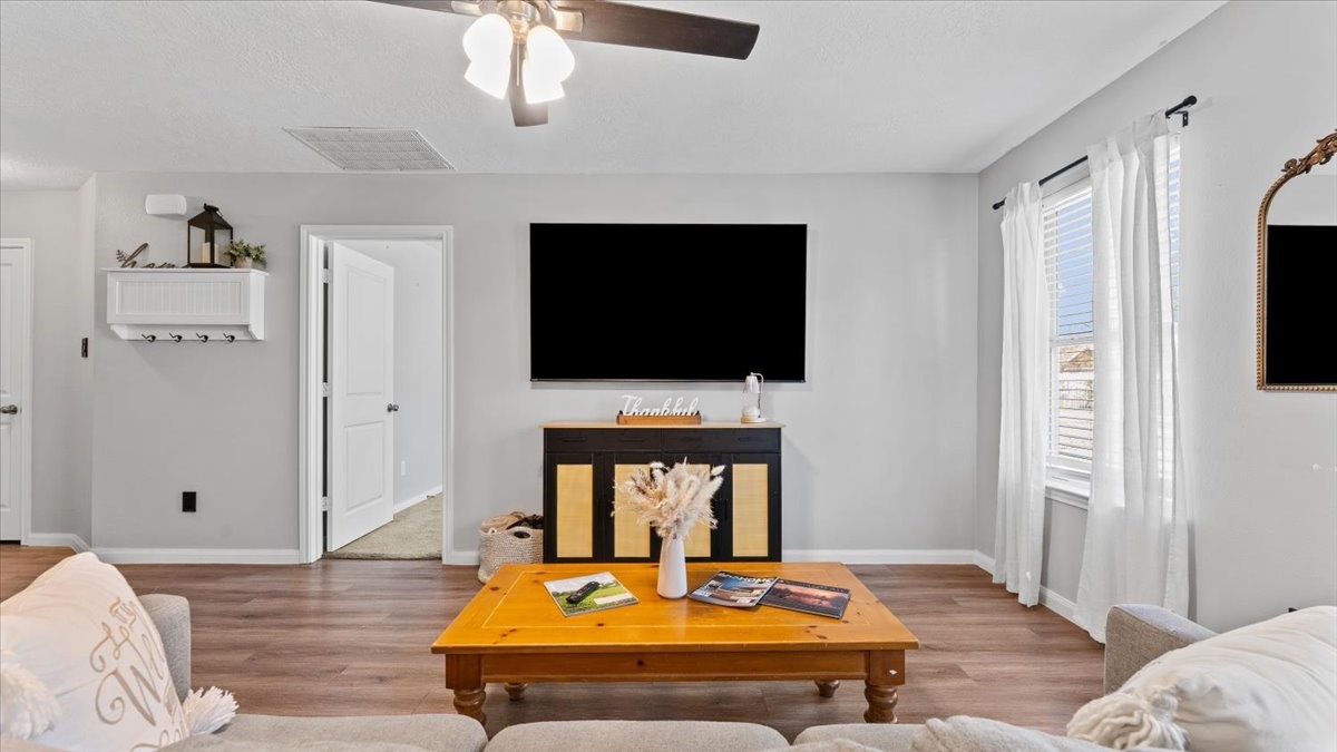 3975 Sam Houston Road Willis, TX 77378 - Photo 14 of 38 a living room with fireplace furniture and a flat screen tv