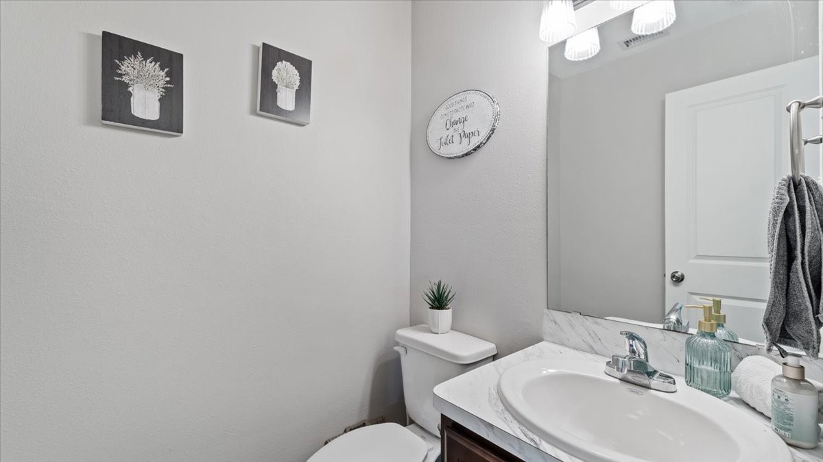 3975 Sam Houston Road Willis, TX 77378 - Photo 15 of 38 a bathroom with a sink mirror and toilet