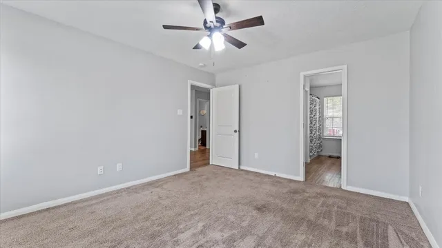 an empty room with fan and a ceiling fan