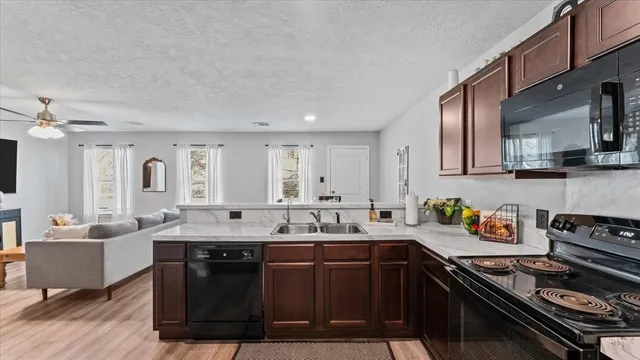a kitchen with stainless steel appliances a sink stove and cabinets