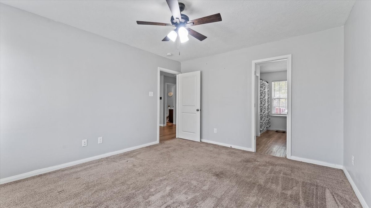 3975 Sam Houston Road Willis, TX 77378 - Photo 21 of 38 an empty room with fan and a ceiling fan