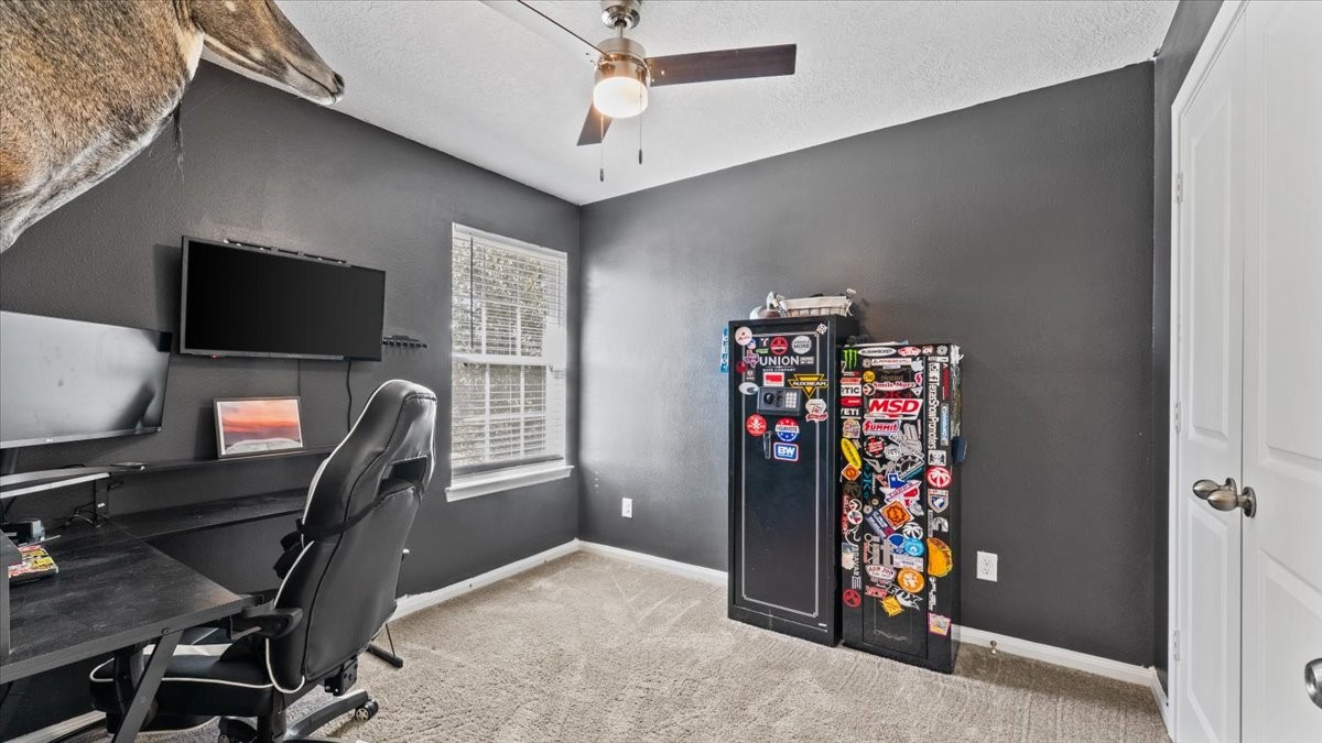 3975 Sam Houston Road Willis, TX 77378 - Photo 23 of 38 a view of a workspace with furniture and gym equipment