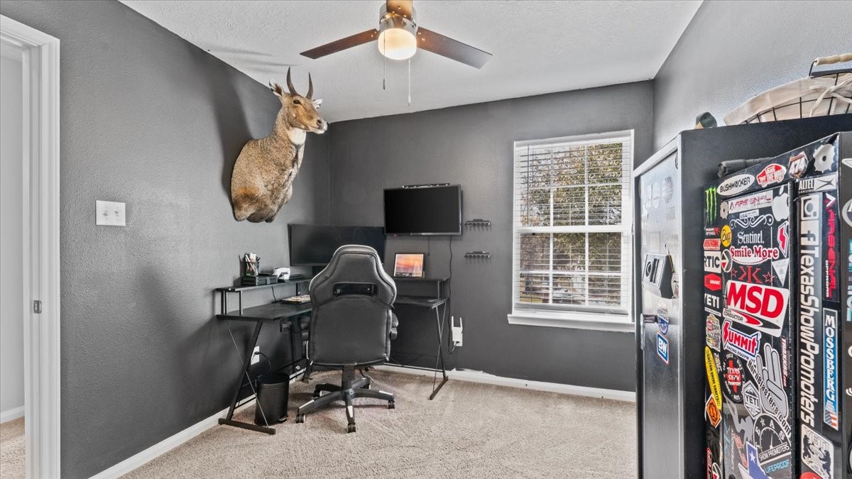 3975 Sam Houston Road Willis, TX 77378 - Photo 24 of 38 a view of a workspace with furniture and a window