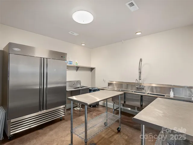 a kitchen with a table chairs and refrigerator