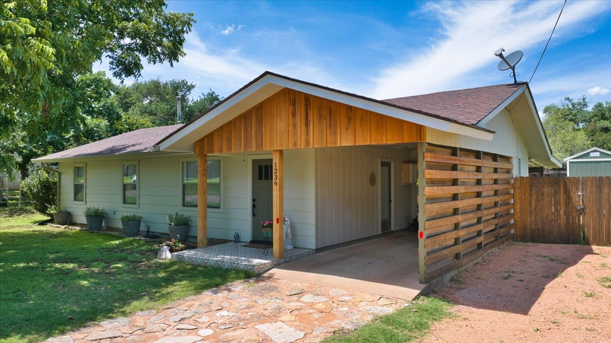 1236 Martin Street Mason, TX 76856 - Photo 40 of 40 A welcoming front exterior with a wooden facade entry and ample green space.