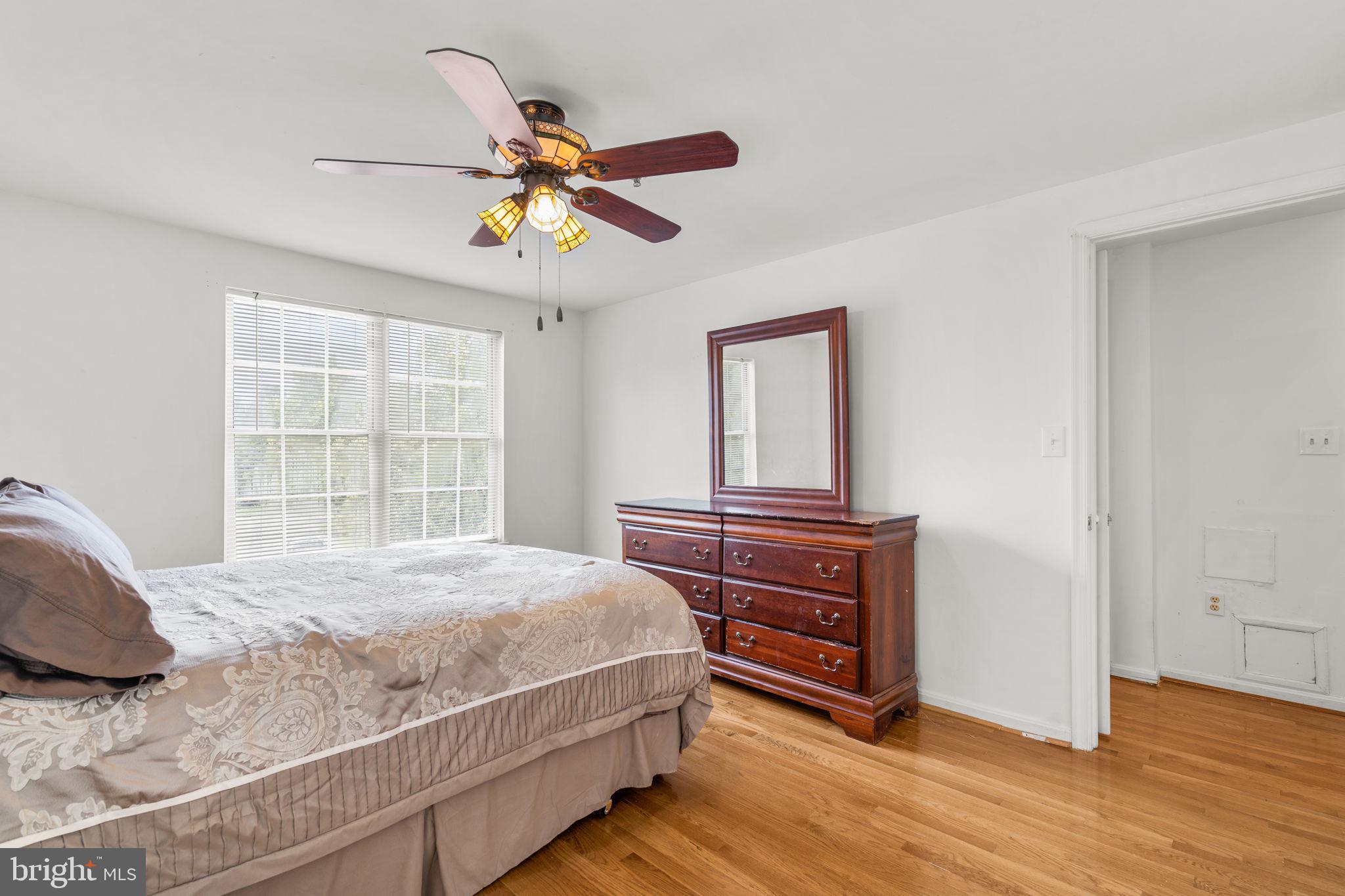 5136 Cranmer Way Capitol Heights, MD 20743 - Photo 22 of 28 a bedroom with a bed and wooden floor