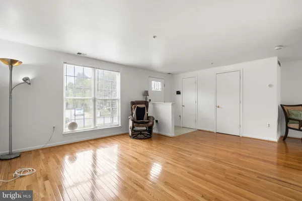 a view of a room with wooden floor and a window