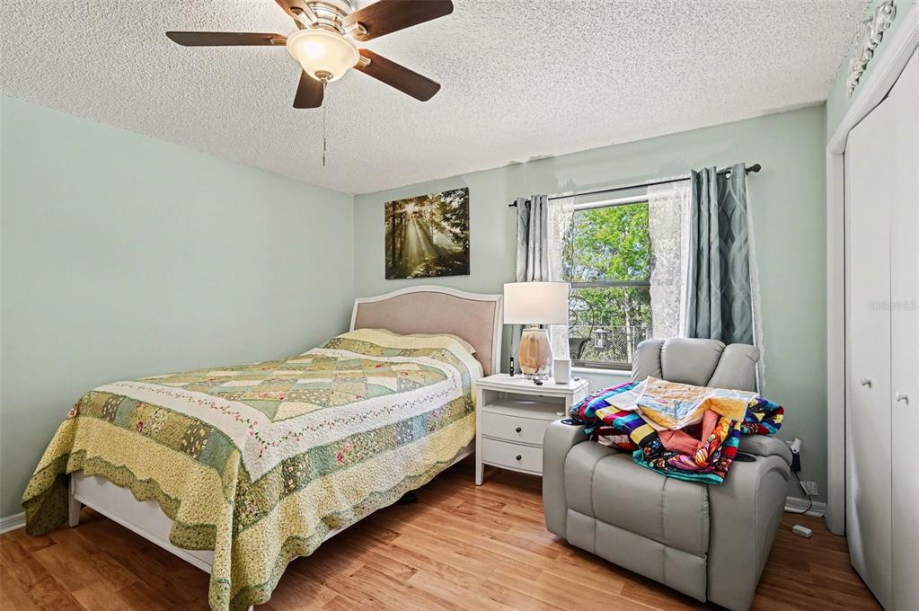 12435 Orangewood Circle Tavares, FL 32778 - Photo 18 of 30 a bedroom with a bed and a chandelier