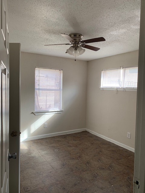 7812 Tierwester Street, Unit 107 Houston, TX 77021 - Photo 3 of 13 an empty room with windows and fan