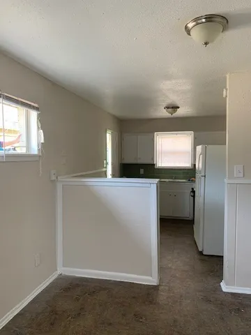 a view of a kitchen and a sink dishwasher and a refrigerator
