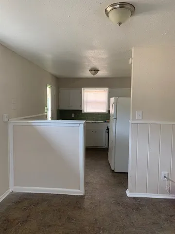 a kitchen with cabinets and stainless steel appliances