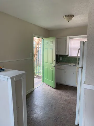 a kitchen with stainless steel appliances a refrigerator sink and cabinets