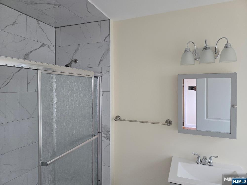 684 Edgewater Avenue, Unit 1 Ridgefield, NJ 07657 - Photo 15 of 20 a bathroom with a sink and mirror