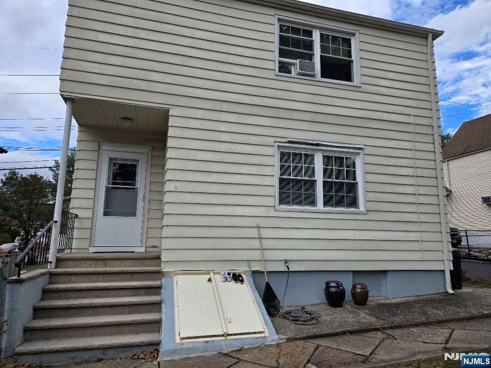 684 Edgewater Avenue, Unit 1 Ridgefield, NJ 07657 - Photo 19 of 20 a view of a house with a door and wooden roof