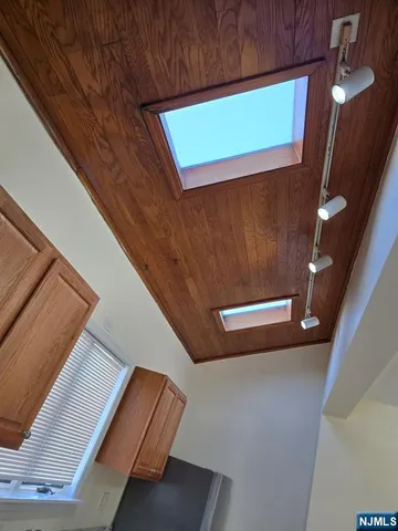 a kitchen with granite countertop a sink and cabinets