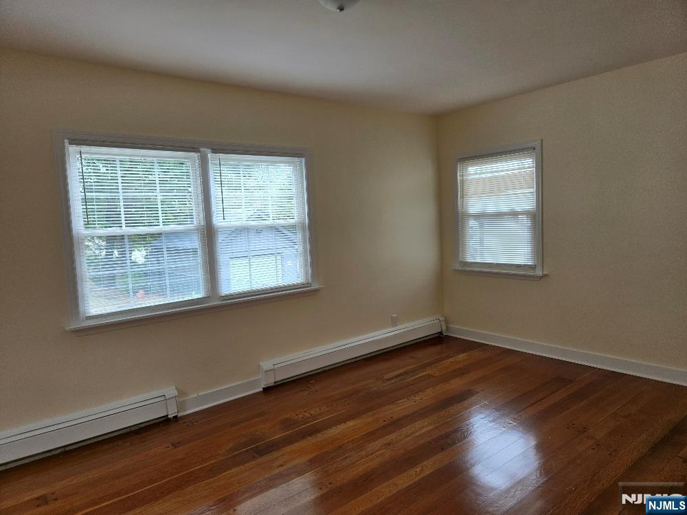 684 Edgewater Avenue, Unit 1 Ridgefield, NJ 07657 - Photo 10 of 20 an empty room with wooden floor and windows