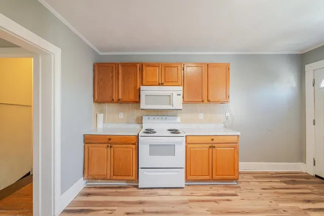 a kitchen with a stove a sink and a refrigerator