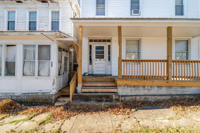 a view of a brick house with a small yard