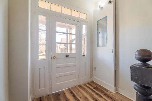 a view of front door with wooden floor