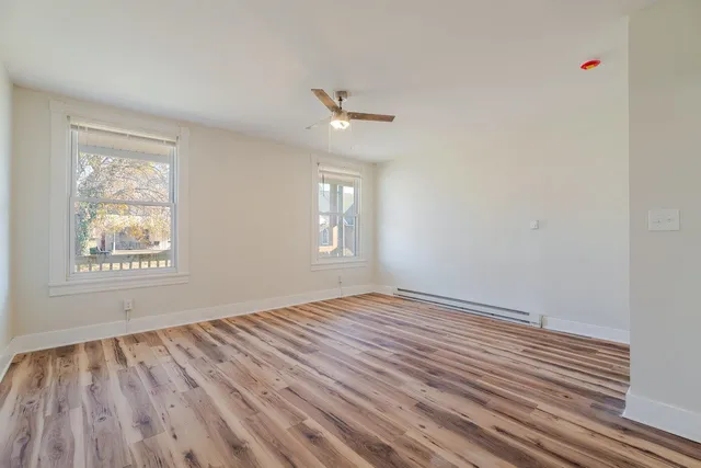 wooden floor in an empty room with a window