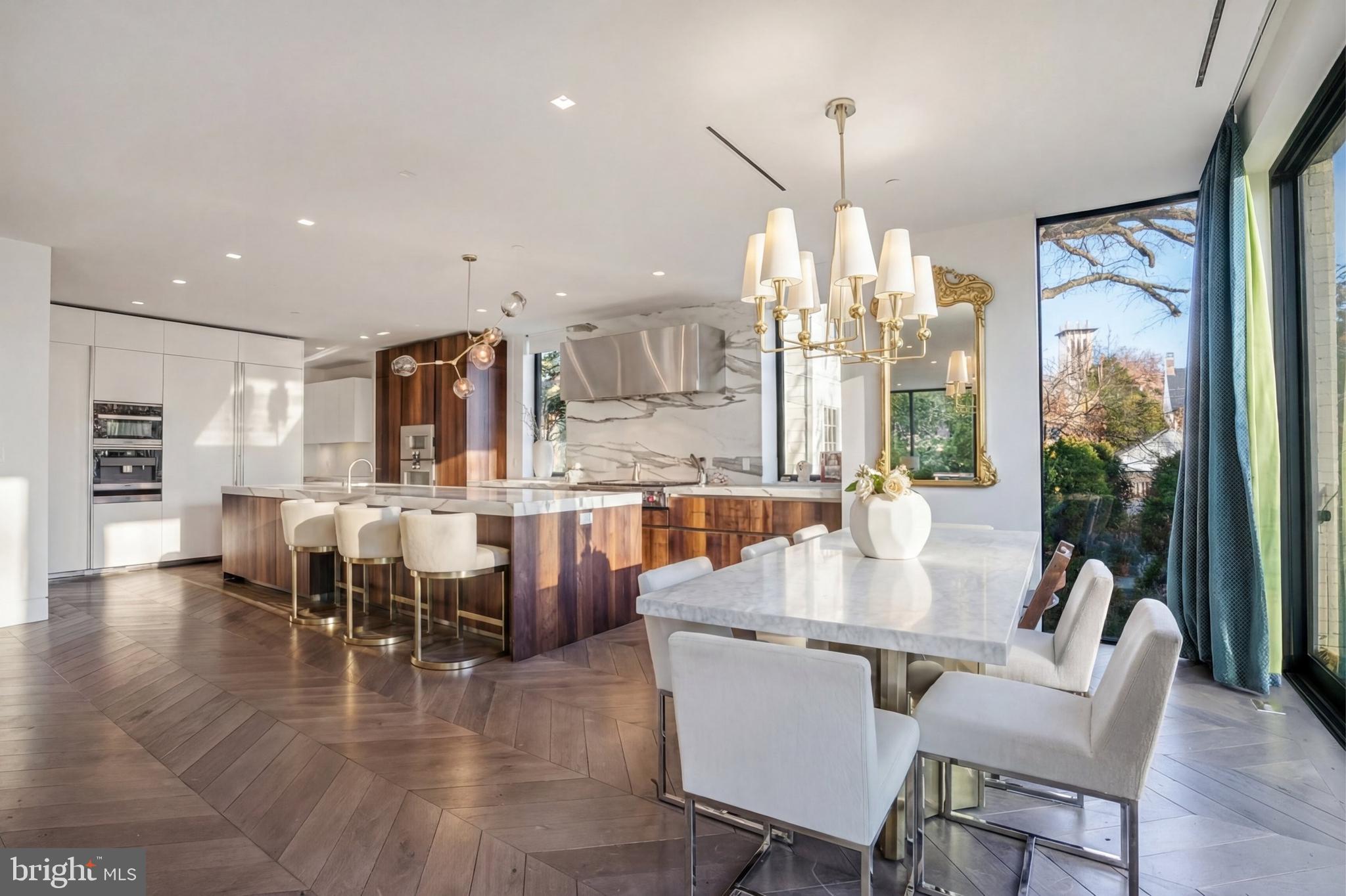 2709 36th Street Northwest Washington, DC 20007 - Photo 11 of 50 a dining room with wooden floor a chandelier a glass table and chairs